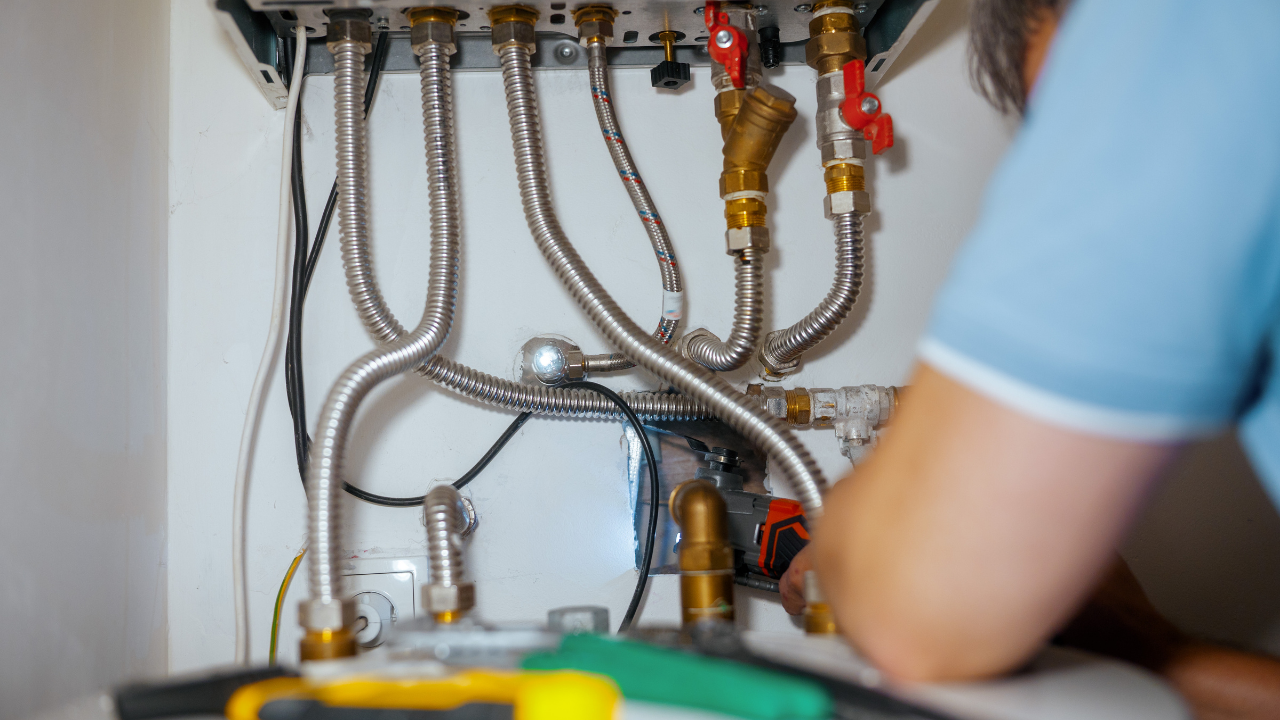 HVAC technician performing furnace maintenance inspection