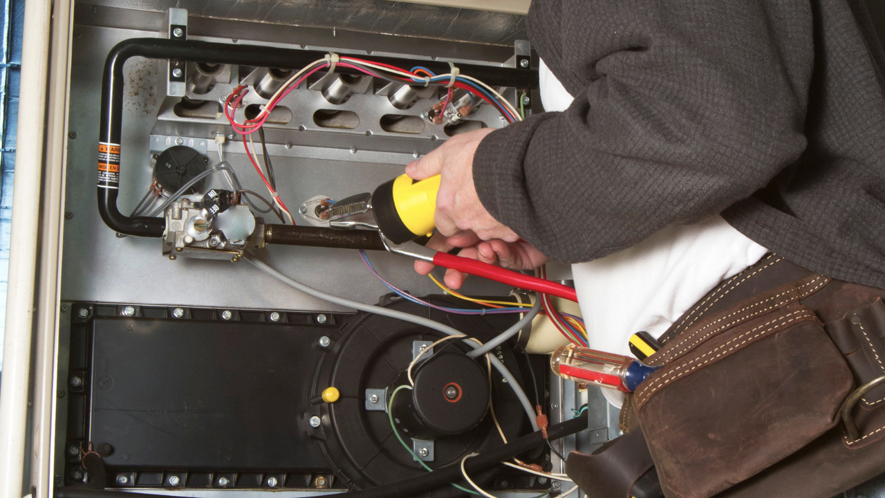 . Technician repairing residential water heater