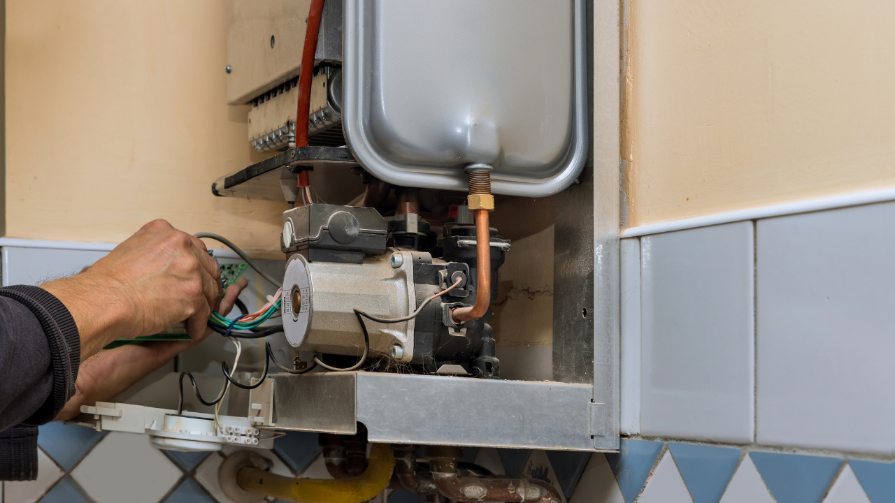 Technician checking refrigerant levels on AC unit in Fresno